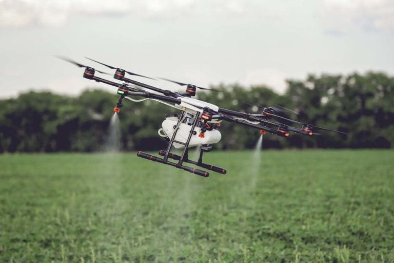 Agriculture drone fly to sprayed fertilizer on the rice fields. Industrial agriculture and smart farming