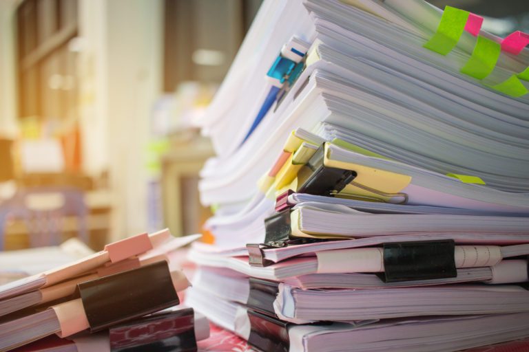 Paper stack Pile of unfinished documents on office desk related to business functions. Stack of business papers for Annual Report files Document is writtendrawnpresented. Business offices concept.