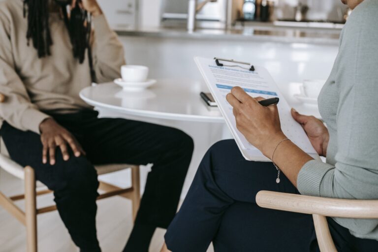 Crop faceless multiethnic interviewer and job seeker going through interview