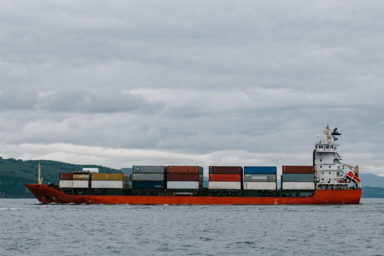 Red Container Ship Under White Clouds