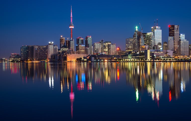 Buildings Near Body Of Water At Night